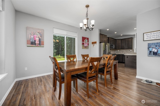 dining room featuring a notable chandelier and dark hardwood / wood-style flooring