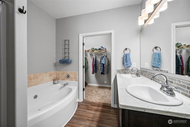 bathroom with vanity, a bathtub, and hardwood / wood-style floors