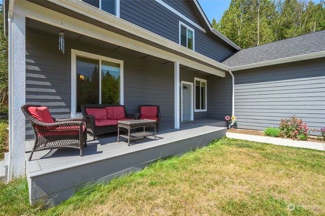 exterior space with an outdoor hangout area, a yard, and a wooden deck