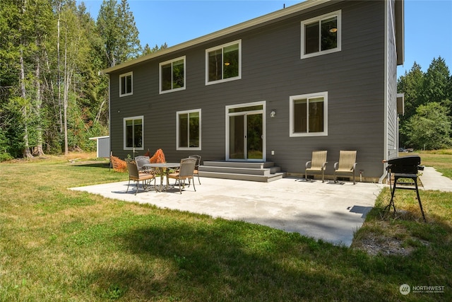 rear view of house featuring a patio and a lawn