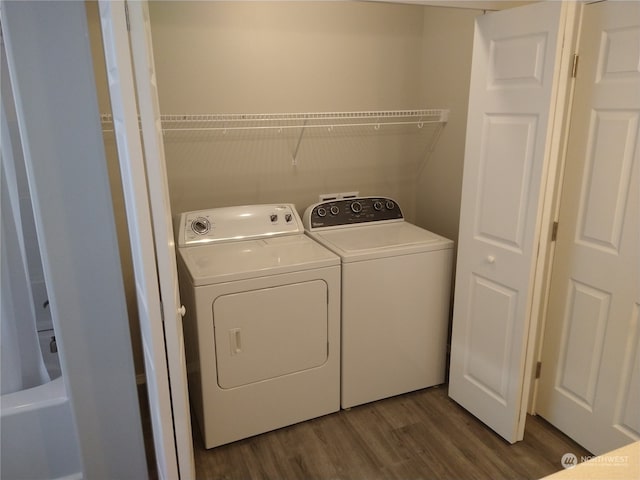 washroom featuring independent washer and dryer and dark wood-type flooring