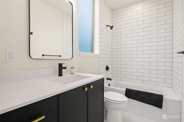 full bathroom with toilet, vanity, and tiled shower / bath