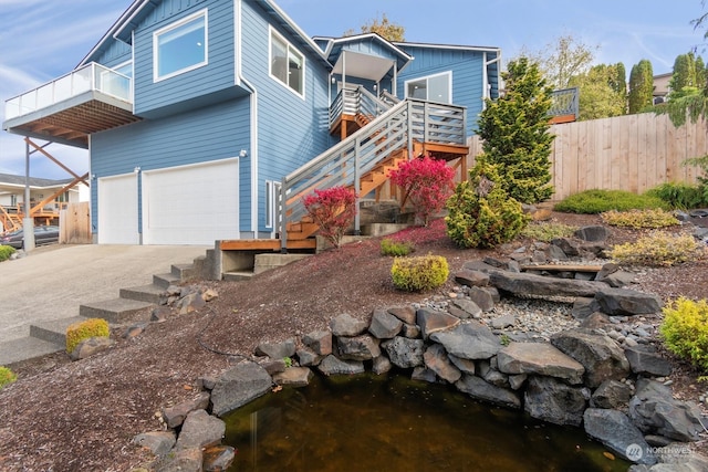 view of front of home featuring a garage and a garden pond