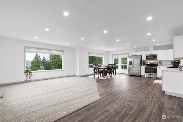 kitchen featuring appliances with stainless steel finishes, white cabinetry, sink, and dark hardwood / wood-style floors