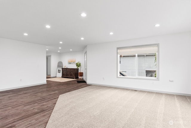 unfurnished living room featuring dark hardwood / wood-style flooring