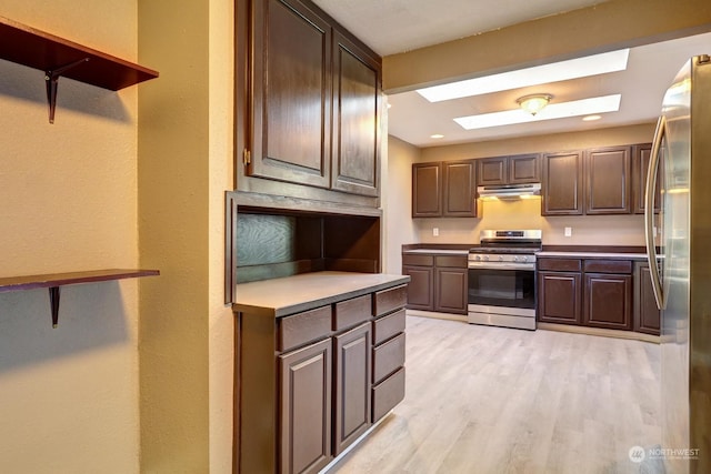 kitchen featuring dark brown cabinets, a skylight, appliances with stainless steel finishes, and light wood-type flooring