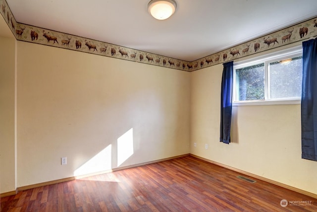 unfurnished room with wood-type flooring