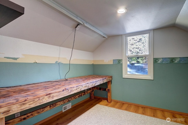 interior space with wood-type flooring and lofted ceiling