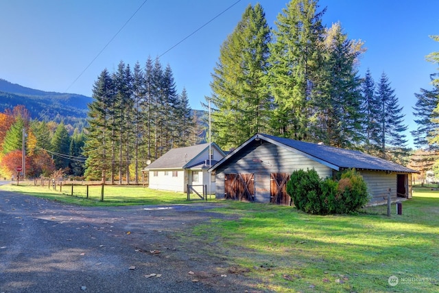 view of home's exterior featuring a mountain view and a lawn