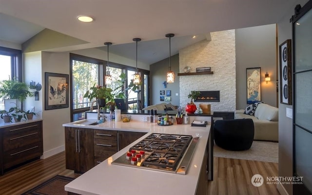 96 Forrest Rd, Sequim, WA 98382 - kitchen featuring stainless steel gas cooktop, lofted ceiling, dark wood-type flooring, light countertops, and open floor plan