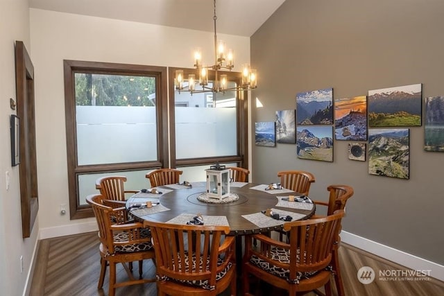 dining space with hardwood / wood-style flooring and a chandelier