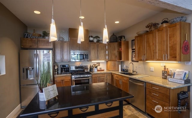 kitchen with sink, stainless steel appliances, hanging light fixtures, and light stone countertops