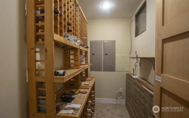 wine room featuring electric panel and light colored carpet