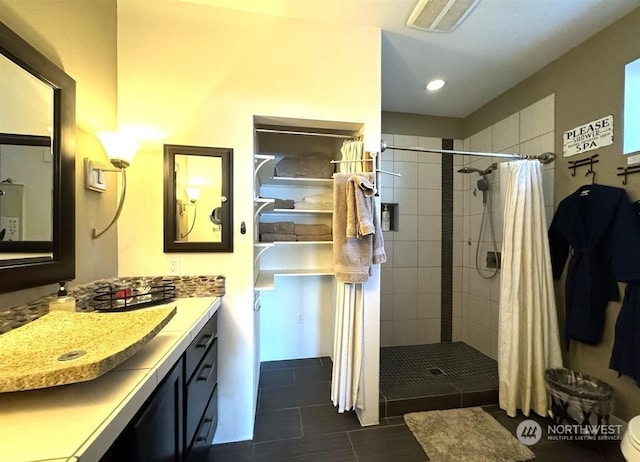 bathroom featuring tile patterned flooring, vanity, toilet, and curtained shower