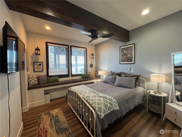 bedroom with beamed ceiling, dark wood-type flooring, and ceiling fan