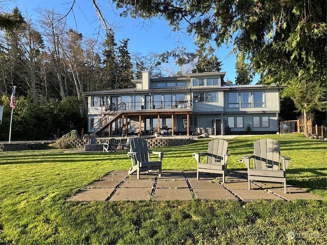 back of property with a patio area, a yard, and a deck