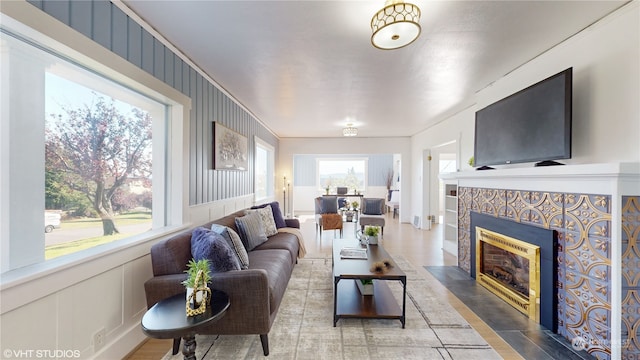 living room with hardwood / wood-style floors and a tile fireplace