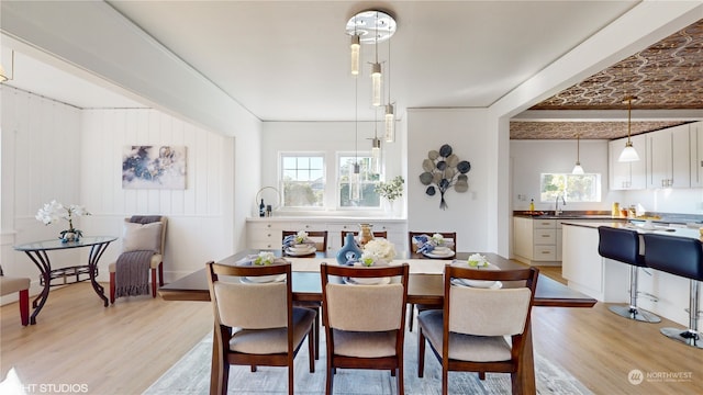 dining space featuring light hardwood / wood-style floors and sink