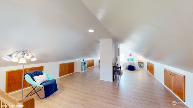 living area with vaulted ceiling and light hardwood / wood-style floors