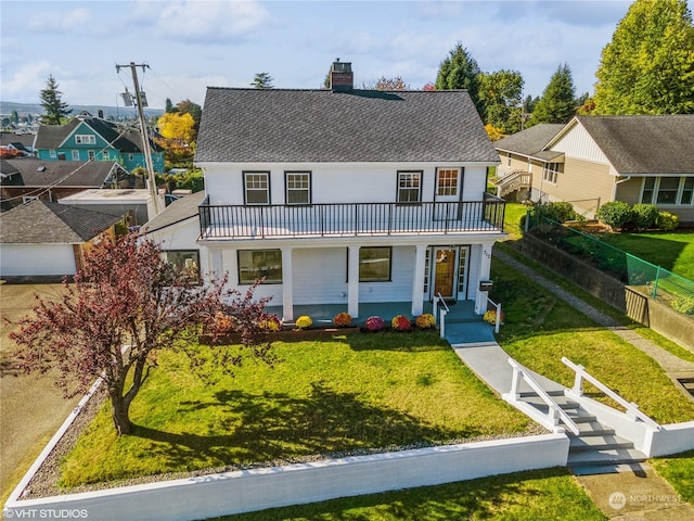 713 N Broadway St, Aberdeen, WA 98520 - view of front of home featuring a front lawn, fence, a balcony, and a chimney