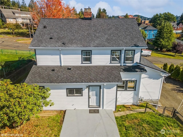 713 N Broadway St, Aberdeen, WA 98520 - view of front facade featuring roof with shingles, fence, and a chimney