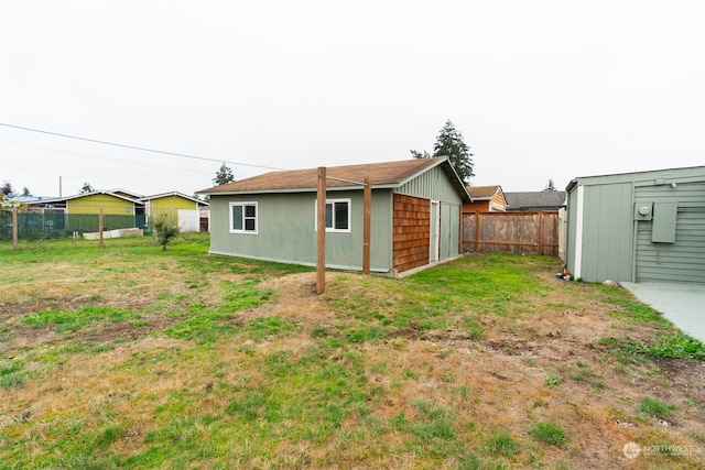 rear view of property featuring a yard