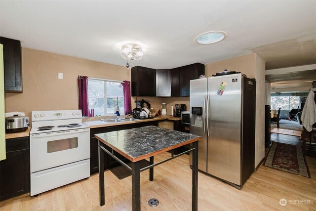10012 Brush Arbor Ln NW, Seabeck, WA 98380 - kitchen featuring stainless steel appliances, light countertops, plenty of natural light, and a sink