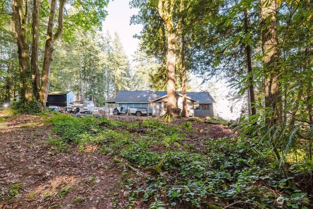 10012 Brush Arbor Ln NW, Seabeck, WA 98380 - view of yard featuring a storage unit and an outbuilding