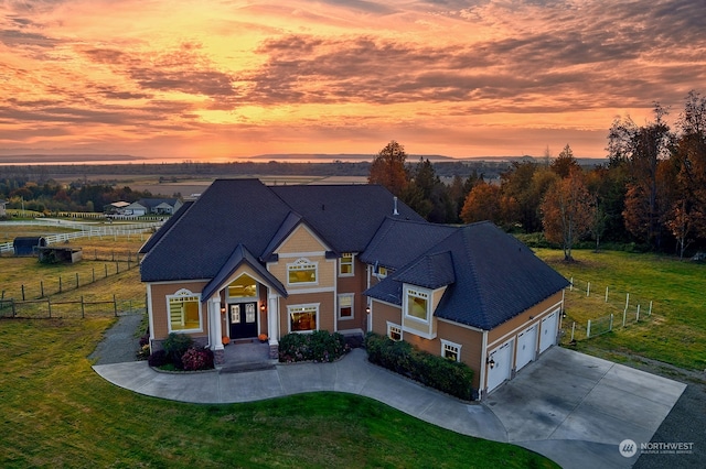 view of front of house with a yard and a garage