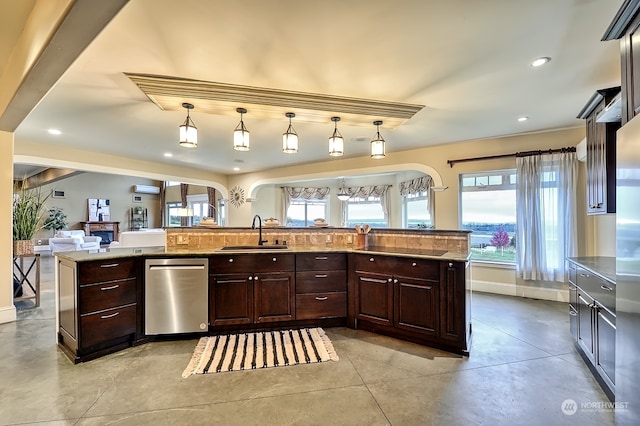 kitchen featuring stainless steel dishwasher, sink, pendant lighting, and a wealth of natural light