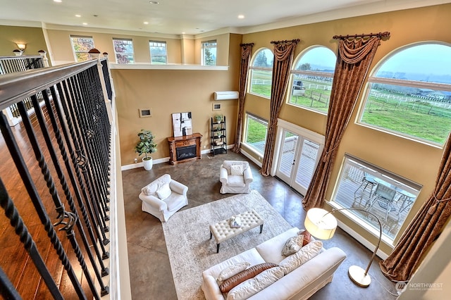 living room with crown molding and a wealth of natural light