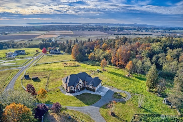 birds eye view of property with a rural view