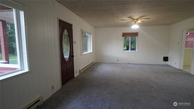 entryway with baseboard heating, a wealth of natural light, and carpet flooring