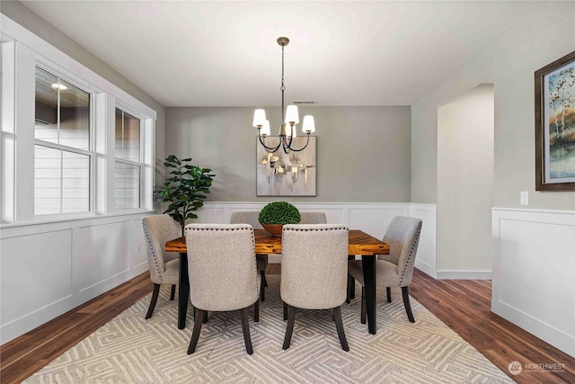 dining space with a chandelier and hardwood / wood-style flooring