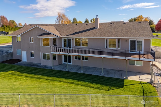 rear view of house with a patio area, a balcony, and a lawn