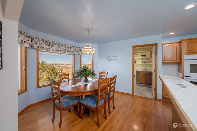 dining space with light wood-type flooring