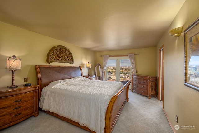 bedroom with access to outside and light colored carpet