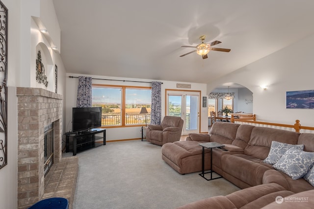 carpeted living room featuring ceiling fan and a brick fireplace