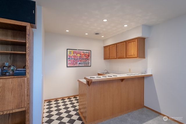 kitchen featuring kitchen peninsula and a breakfast bar area