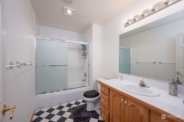 full bathroom with vanity, enclosed tub / shower combo, and toilet