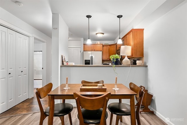 dining space featuring light wood-type flooring