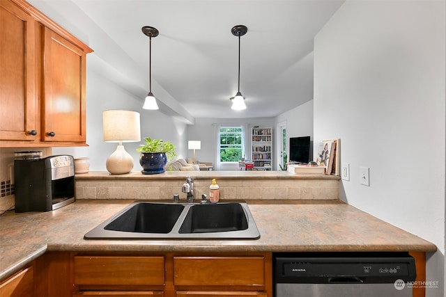 kitchen featuring pendant lighting, dishwasher, and sink