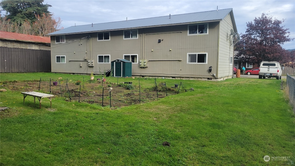 rear view of property with a yard