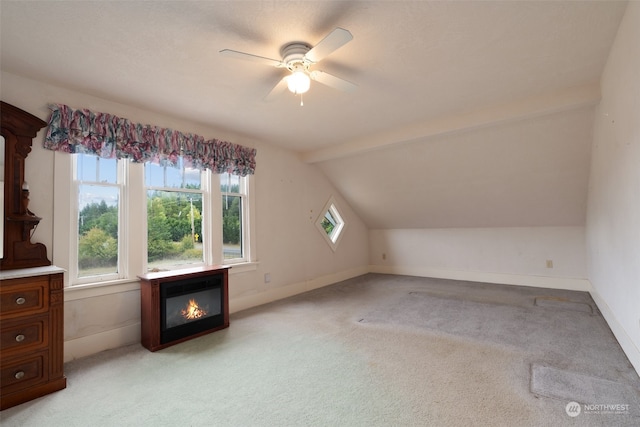 bonus room with vaulted ceiling, light carpet, and a healthy amount of sunlight