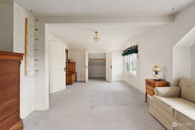 interior space featuring light carpet and beam ceiling