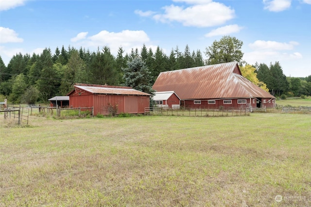 view of yard with a rural view and an outbuilding