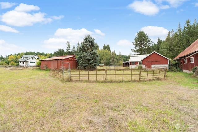 view of yard featuring an outdoor structure and a rural view