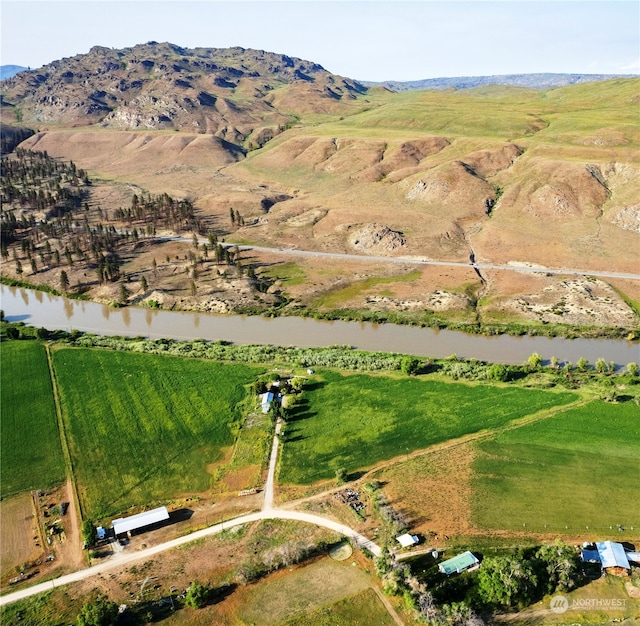 drone / aerial view with a rural view and a water and mountain view