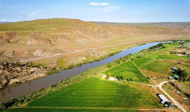 drone / aerial view with a rural view and a water and mountain view