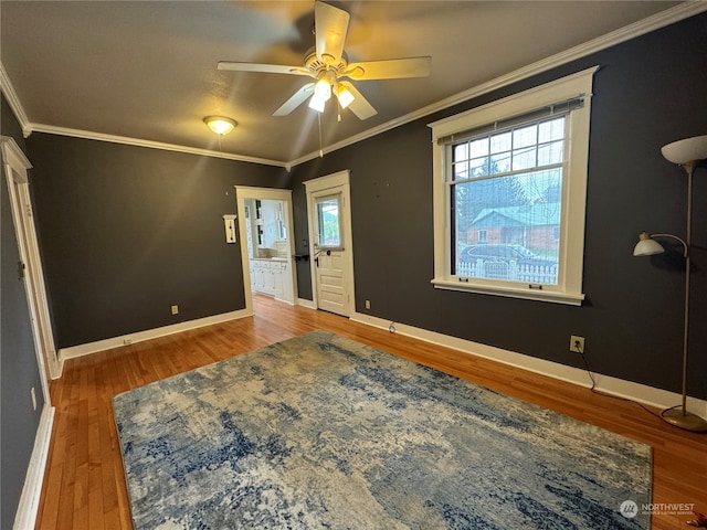 interior space with crown molding, ceiling fan, and wood-type flooring